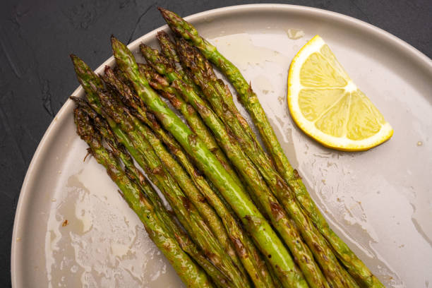 istock Fresh green asparagus on the black background 2143858657