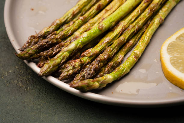 istock Fresh green asparagus on the green  stone background 2143859180
