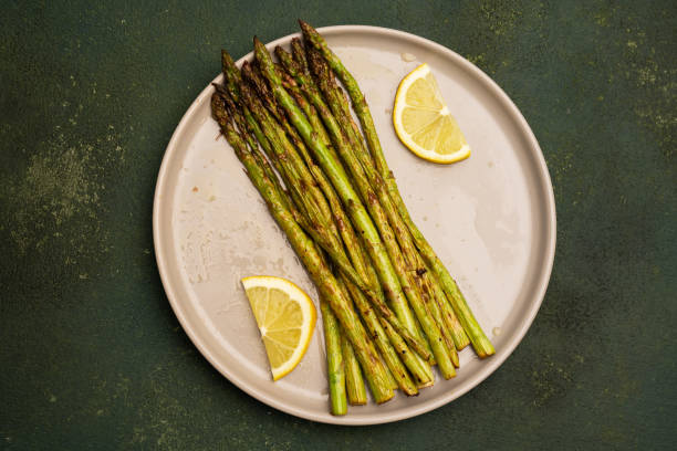 istock Fresh green asparagus on the green  stone background 2143859183