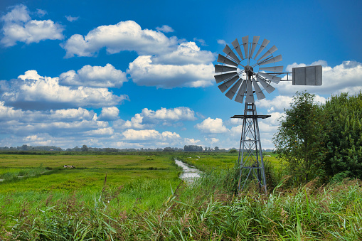 A water mill, used to regulate water levels in low-lying areas, in the low moorland swamp of National Park De Alde Feanen in the province of Friesland, the Netherlands
