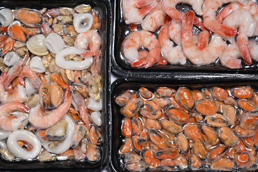 Plastic packages with seafood close up