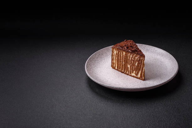 istock Delicious fresh cheesecake cake or snickers with cream and nuts on a ceramic plate 2143997132