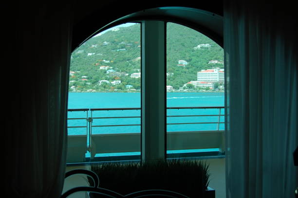 istock a balcony view is seen through a window at dusk while the sun rises 2144003419