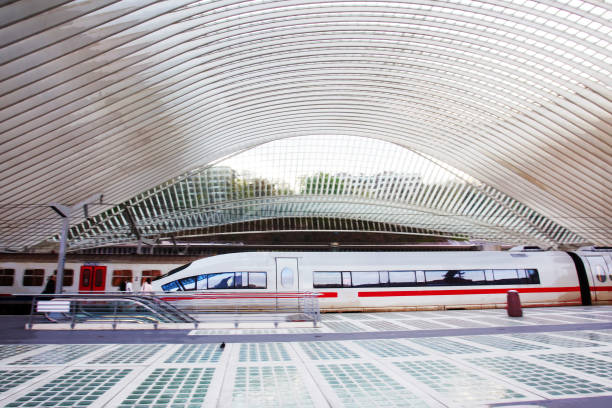 04-19-2016  Liege  BELGIUM  Speed train on   futuristic train station Liege. People on far distance.