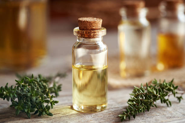 istock A transparent bottle of aromatherapy essential oil with fresh thyme on a table 2144066523