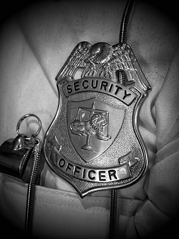 Security officer badge in monochrome.