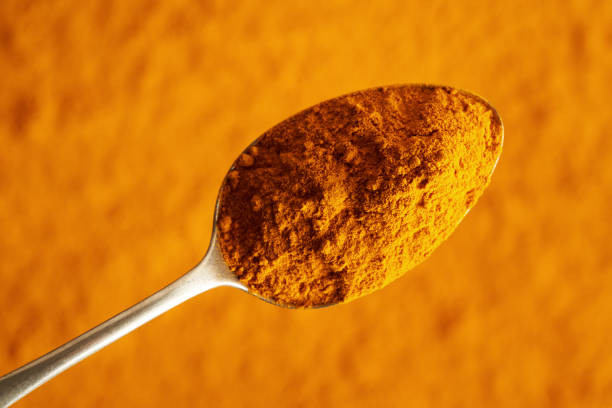 istock Turmeric root powder on a metal spoon 2144079061