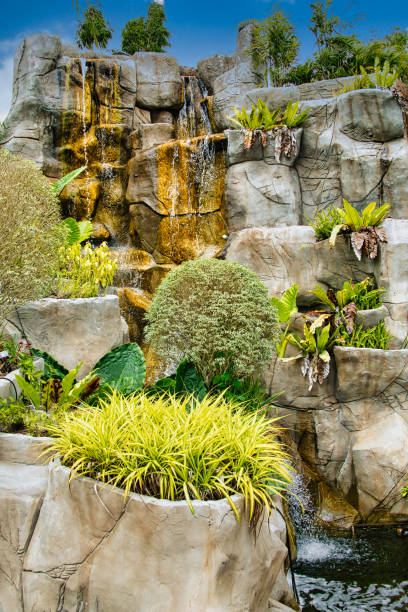 istock Artificial waterfall with ferns and other vegetation 2144079633