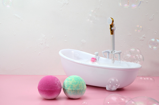 Bath bombs in bathroom, soap bubbles, bathtube miniature, copys space