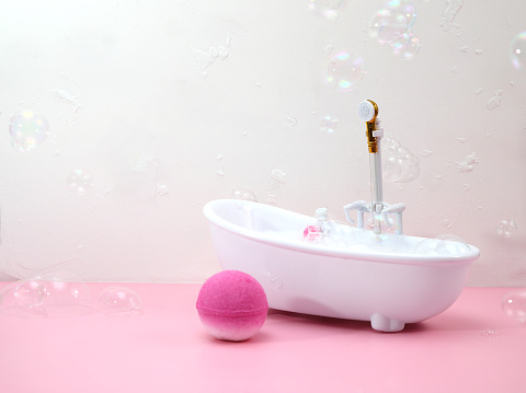 Bath bombs in bathroom, soap bubbles, bathtube miniature, copys space