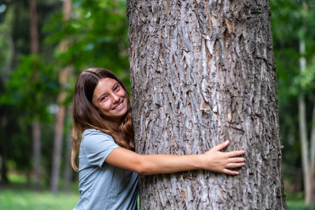 istock the girl hugs the tree 2144128388