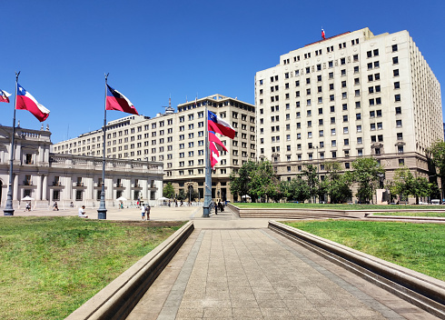 Left, Palacio de la Moneda, (government house), right, Ministry of Foreign Affairs, from the Plaza de la Constitución. Metropolitan region, Santiago, Chile.