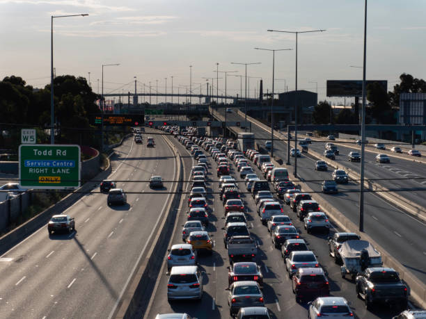Traffic and traffic signs on freeway Traffic on Melbourne's Westgate Freeway, exciting Melbourne speed limit sign australia stock pictures, royalty-free photos & images