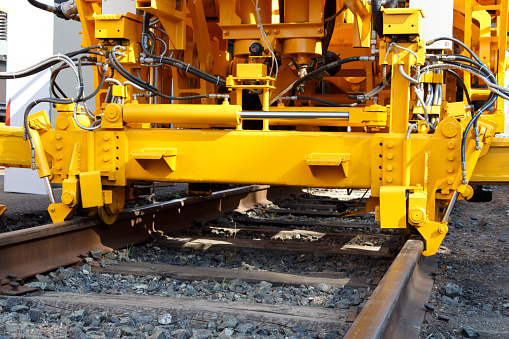 Yellow railway engineering equipment on the railway track.