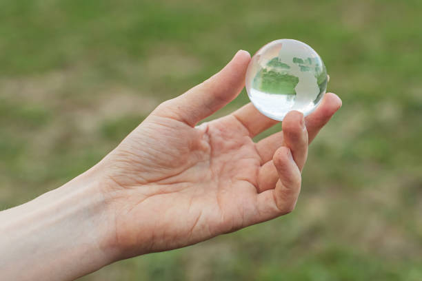 istock Planet Earth. Glass globe in hand. Sustainability. 2144386684