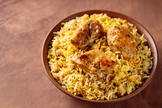 istock Indian Traditional Chicken Biryani Rice in Bowl on Brown Background, Copy Space 2144397719