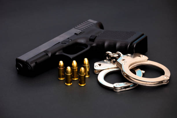 istock Hand gun with ammunition on dark background. 2144428682