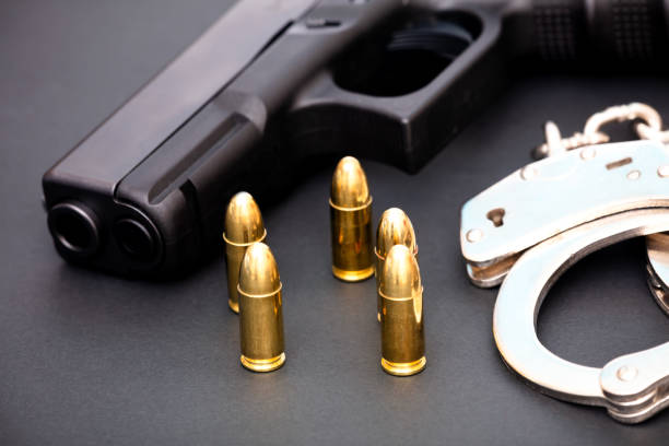 istock Hand gun with ammunition on dark background. 2144428686