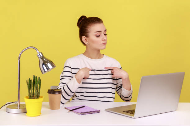 istock Self confident woman worker pointing herself and looking at laptop screen with arrogant expression. 2144526646
