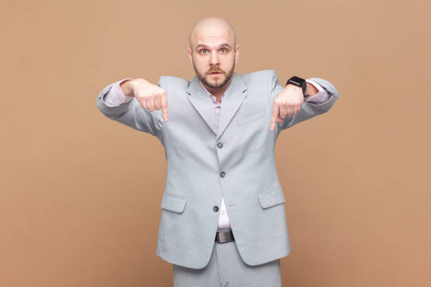 istock Man pointing down and looking with arrogance, demanding immediate submission demonstrating authority 2144528312