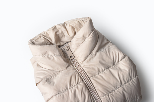 Beige padded coat zipper ,down jacket, rain proof winter jacket on white background.Top view