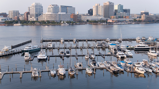Boats and yachts are moored at the river pier. Norfolk Downtown, VA aerial view from Portsmouth