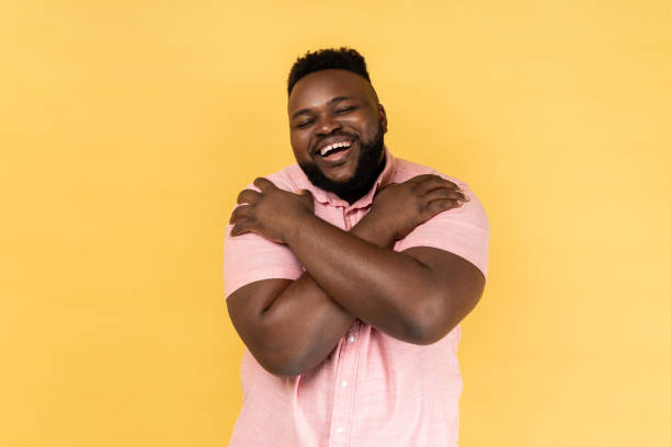 istock Man embracing himself and smiling with expression of great ego, pleasure and self-esteem. 2144546621