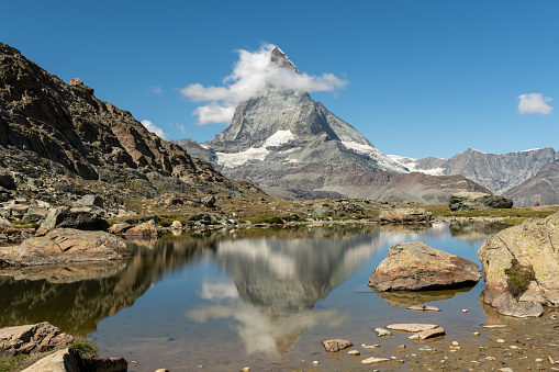 Switzerland travel - Female hiking around the Riffelsee in Zermatt, with fantasic view of the Matterhorn