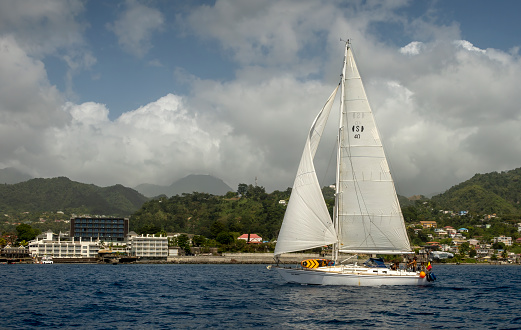 Roseau, Dominica - 25th February 2024: A yacht sailing close to Roseau, Dominica