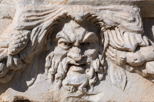 Dramatic Greek theater mask relief from Aphrodisias, expressive ancient craftsmanship in marble with textured details. October 11, 2023. Ancient Aphrodisias city, Geyre, Turkey (Turkiye)