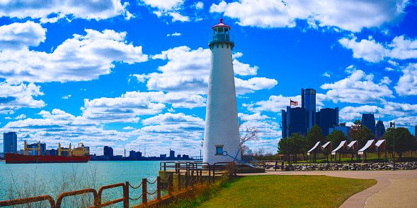 Detroit City Skyline and Milliken State Park Lighthouse, the iconic light tower at the harbor marina along the Detroit River in Michigan, USA
