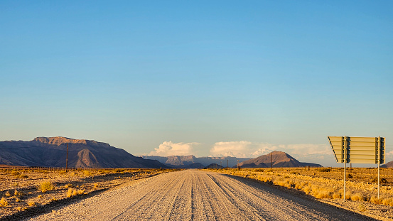 Empty road in desert in sunset