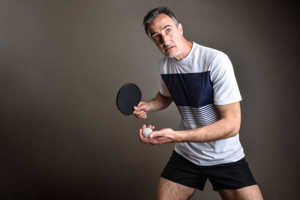 istock Ping-pong player ready to make a serve on gray background 2144646674