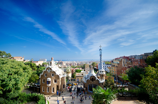 View at Park Guell with Gaudi's famous gingerbread houses and tourists