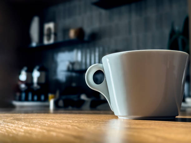 istock White cup of coffee on the table. 2144707251