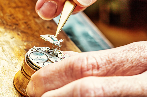 Skilled hands bring life to metal, as the heart of a watch is finely tuned
