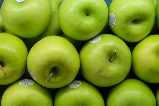 Close-up shot stack of green apple at supermarket