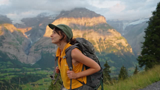 Cheerful woman on hiking trail in Switzerland