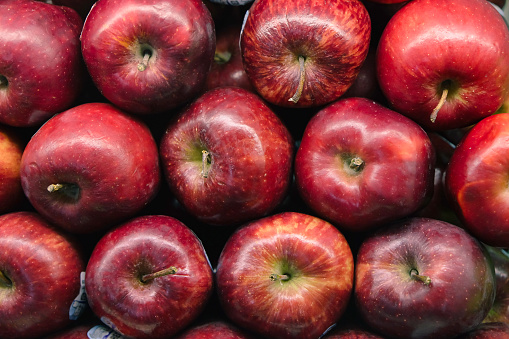Close-up shot stack of red apples at supermarket