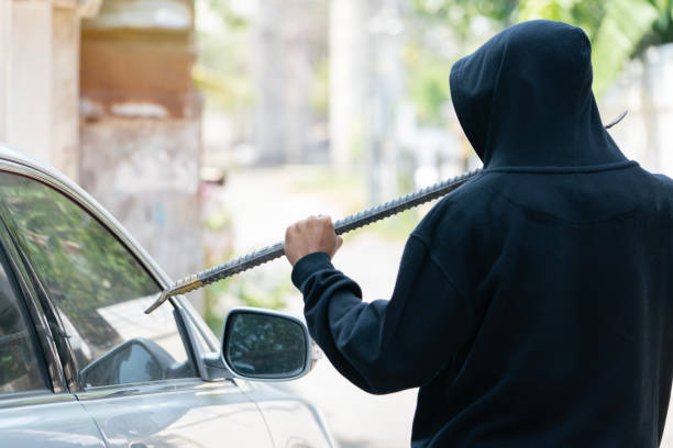 side view of car thief in action