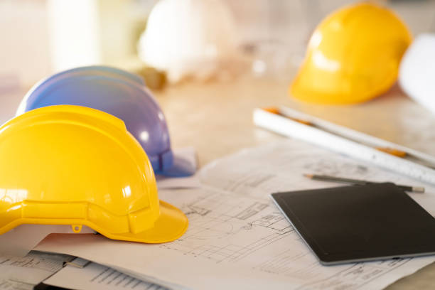 istock engineer or architect desk with helmet and blur blueprint background in the office, project ideas concept. 2144921562