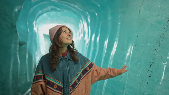 Woman exploring ice cave