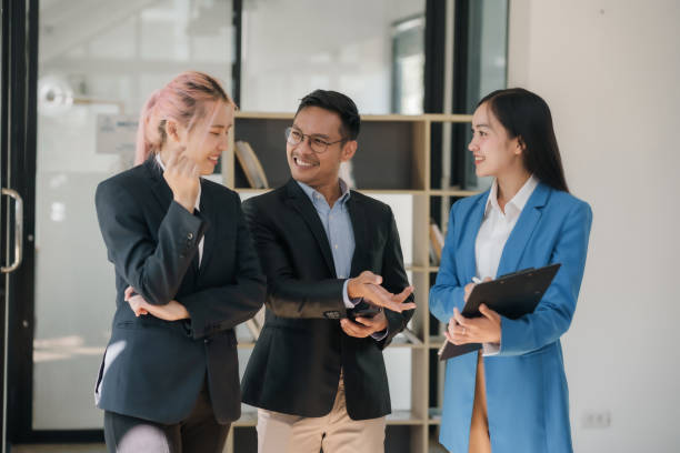 istock Business colleagues reviewing content on a clipboard. Teamwork and project discussion concept. 2144958365