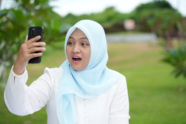 istock Asian woman holding a cellphone 2144959081