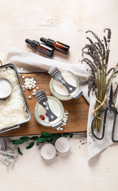 istock DIY. Crafting white aroma candles on light wood background. 2144964401