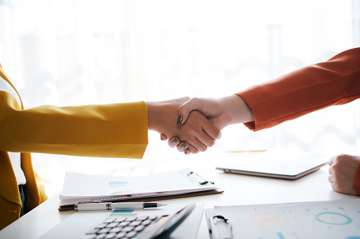 Business handshake. Businessman shaking hands agreement confirmed in the investment business.
