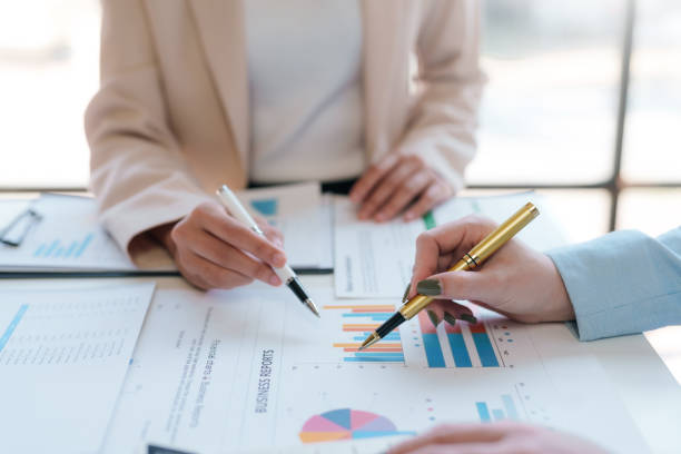 istock Teamwork process. Business people pointing at business document during discussion at meeting. 2144989412