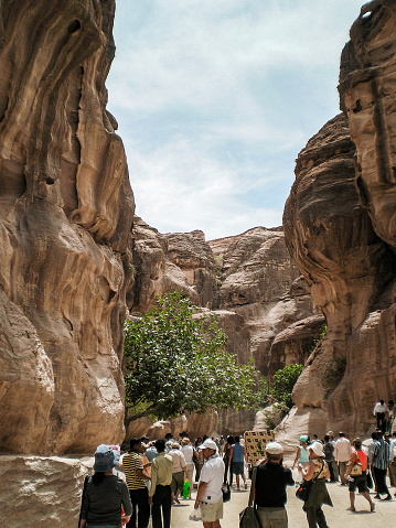 Wadi Musa, Jordan, April 18, 2008 : Numerous tourists pass through gorge Al Siq of Historical Reserve of Petra near city of Wadi Musa which is home to Petra in Jordan