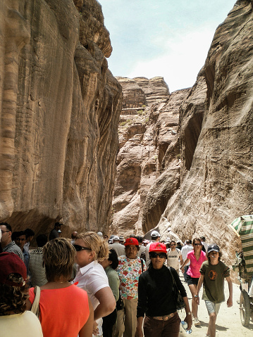 Wadi Musa, Jordan, April 18, 2008 : Numerous tourists pass through gorge Al Siq of Historical Reserve of Petra near the city of Wadi Musa which is home to Petra in Jordan