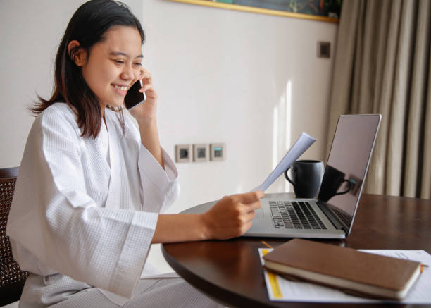 istock Smiling Young Indonesian Gen Z Working From Hotel Room 2145049648